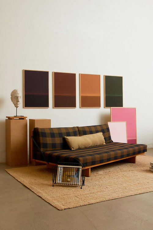 Art print with an abstract spray painting of a dark sky in deep purple tones. Styled in a minimalist interior.