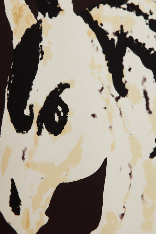 Art print with a stylized illustration of a horse head in light beige and black tones against a dark brown background, with an intentionally blurred and painterly feel. Styled in a minimalist interior.