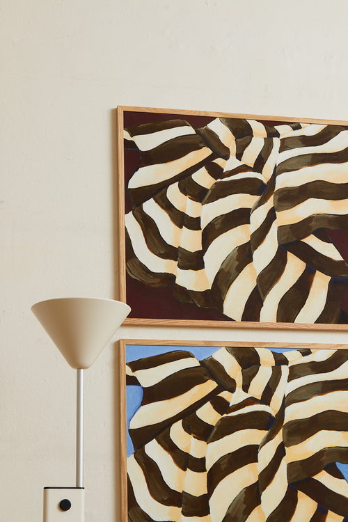 Art print featuring a painting of a plaid against a deep burgundy background, flowing with wide stripes in dark chocolate brown and creamy white. Styled in a minimalist interior.