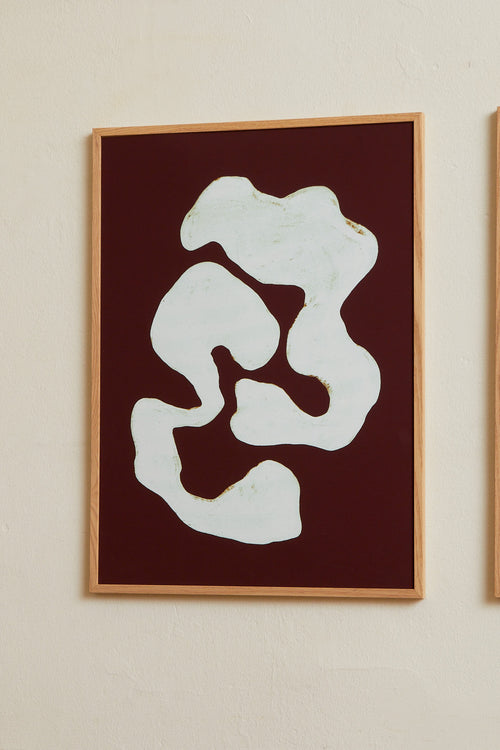 Art print featuring two analogue-themed components wrapping around one another in ice blue against a burgundy background. Styled in a minimalist interior.