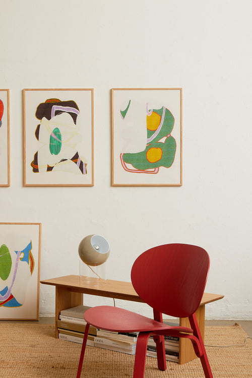 Art print with an abstract artwork featuring soft, overlapping shapes and a grainy texture. Green tones meet light fields and are framed by a distinct yellow core. Styled in a minimalist interior.