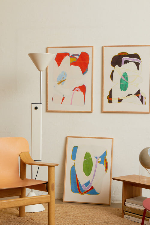 Art print with an abstract artwork featuring soft, overlapping shapes and a grainy texture. Blue tones meet light fields and are framed by a distinct green core. Styled in a minimalist interior.