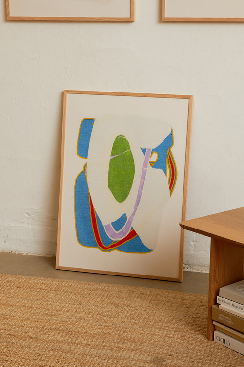 Art print with an abstract artwork featuring soft, overlapping shapes and a grainy texture. Blue tones meet light fields and are framed by a distinct green core. Styled in a minimalist interior.