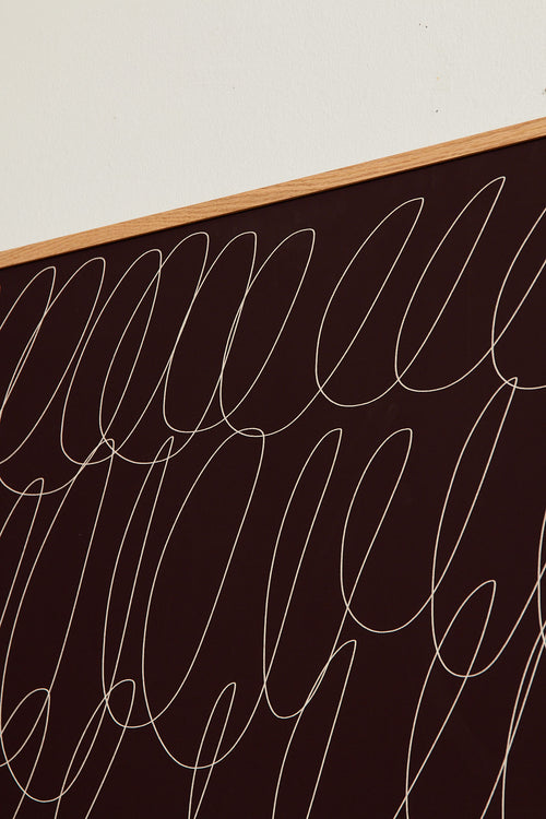 Art print with a graphic illustration of sweeping, continuous lines in a light tone against a wine-red background, with a minimalist and abstract expression. Styled in a minimalist interior.