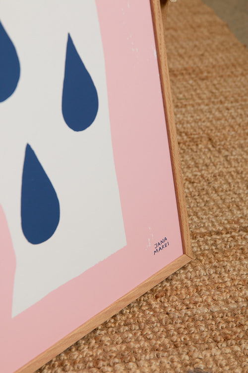 Art print featuring a silhouette of a head in profile with drops and the handwritten note “The Distance”. Styled in a minimalist interior.