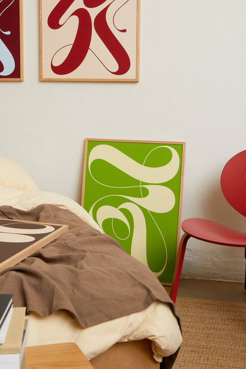 Art print featuring exploratory organic forms emerging in two shades of green. Styled in a minimalist interior.