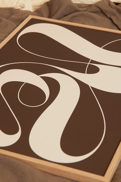 Art print featuring exploratory organic forms emerging in brown and sand beige. Styled in a minimalist interior.