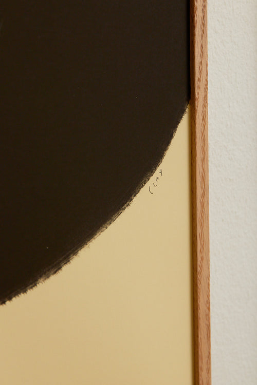 Art print with a minimalist illustration of a large, rounded color field in a dark brown tone against a light beige background. Styled in a minimalist interior.