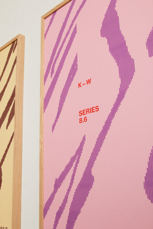 Art print with a graphic illustration of sweeping, organic forms built from dense lines, complemented by small text elements, in pink and purple RAL colors. Styled in a minimalist interior.