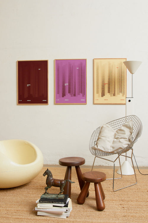 Art print with a graphic illustration of vertical fields built from dense lines, complemented by small text elements, in red and purple RAL colors. Styled in a minimalist interior.