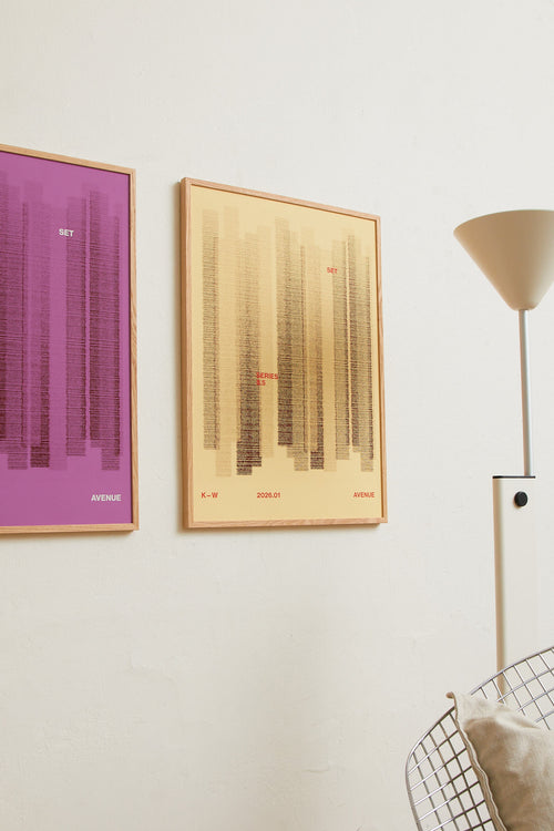 Art print with a graphic illustration of vertical fields built from dense lines, complemented by small text elements, in brown and beige RAL colors. Styled in a minimalist interior.