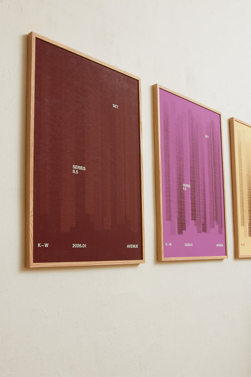 Art print with a graphic illustration of vertical fields built from dense lines, complemented by small text elements, in brown and red RAL colors. Styled in a minimalist interior.