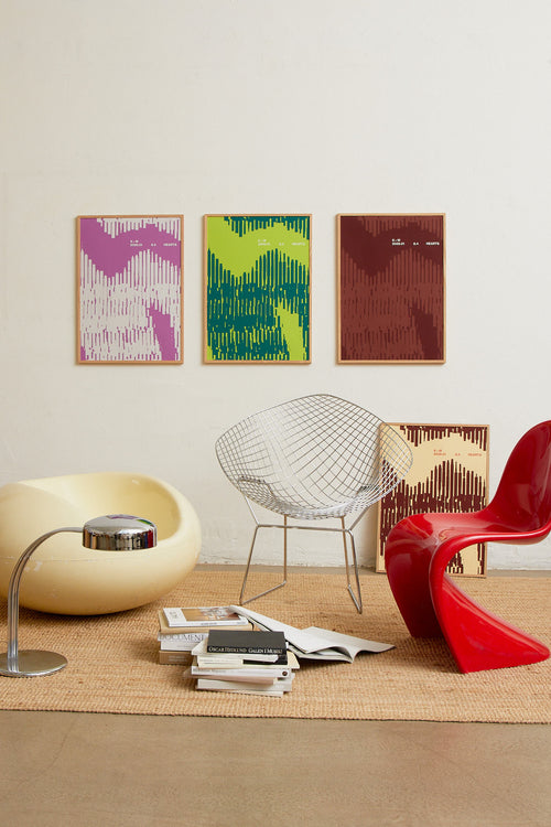 Art print with a graphic illustration of organic, vertical line patterns forming abstract shapes, complemented by small text elements, in green RAL colors. Styled in a minimalist interior.