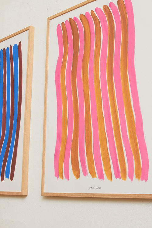 Pink striped art print framed and displayed on a light wall