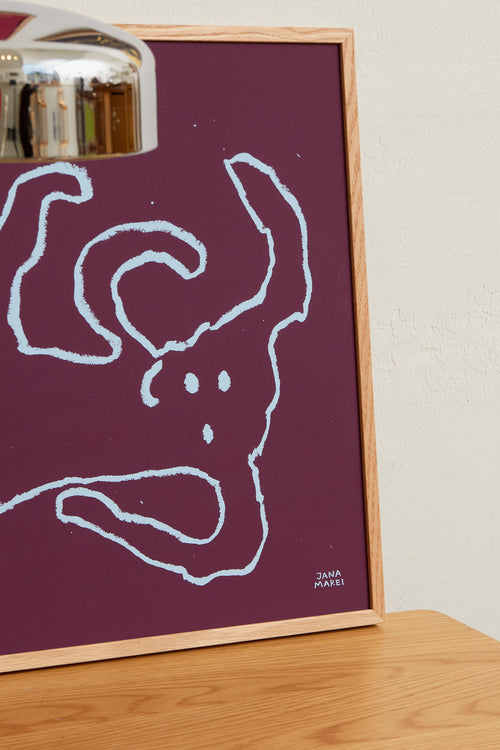 Interior scene with burgundy abstract prints displayed on a wall