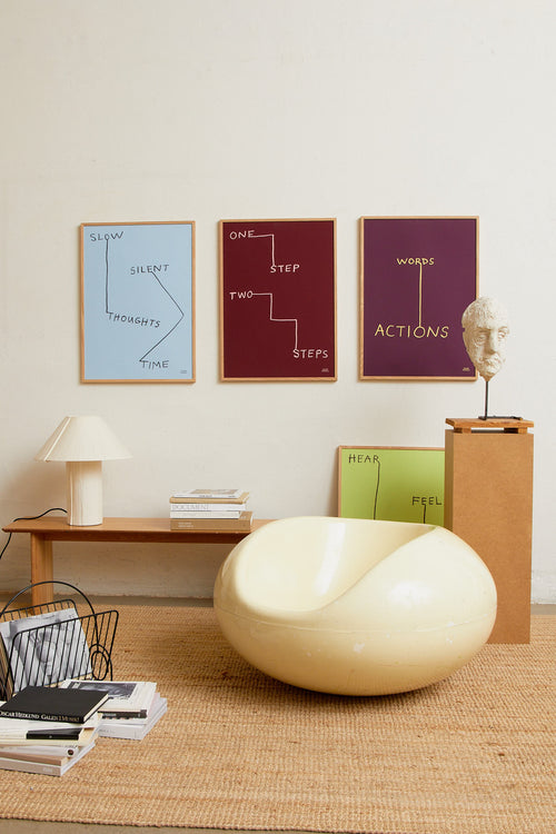 Interior scene with multiple minimalist art prints displayed on a wall