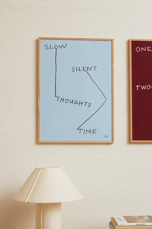 Interior scene with blue and red minimalist prints displayed on a wall