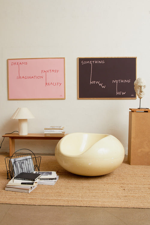 Art print featuring pink handwritten lettering that connects words in an illustrative way on a brown background, creating a new context. Styled in a minimalist interior.