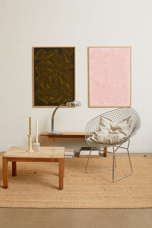 Art print with dense, rounded shapes in two shades of pink with a smooth, glossy feel. Styled in a minimalist interior.