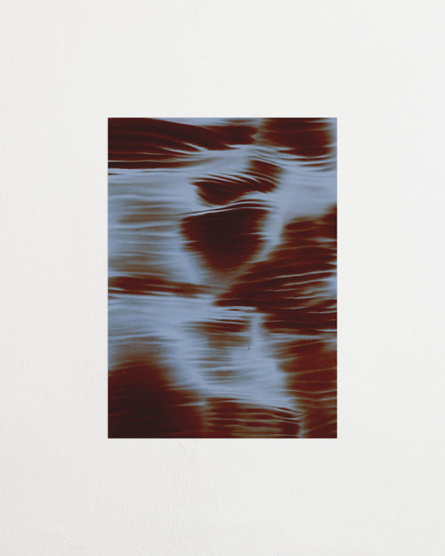 Art print featuring soft, blurred contours and flowing light blue shapes emerging against a dark red-brown surface, creating an impression of motion and impermanence. Featured against a light background.