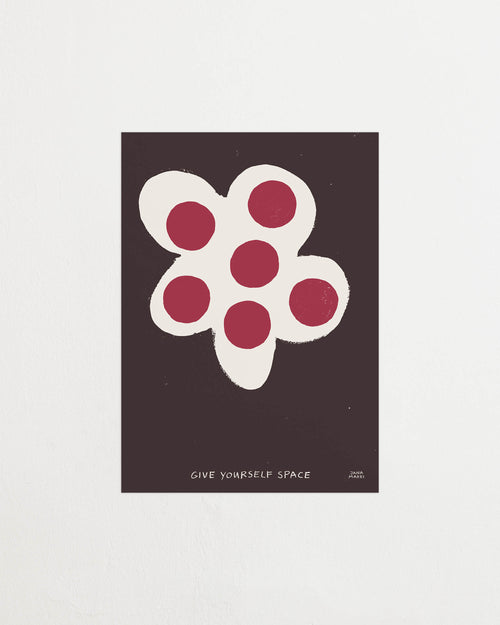 Close-up of the flower print showing white petals and red circular details