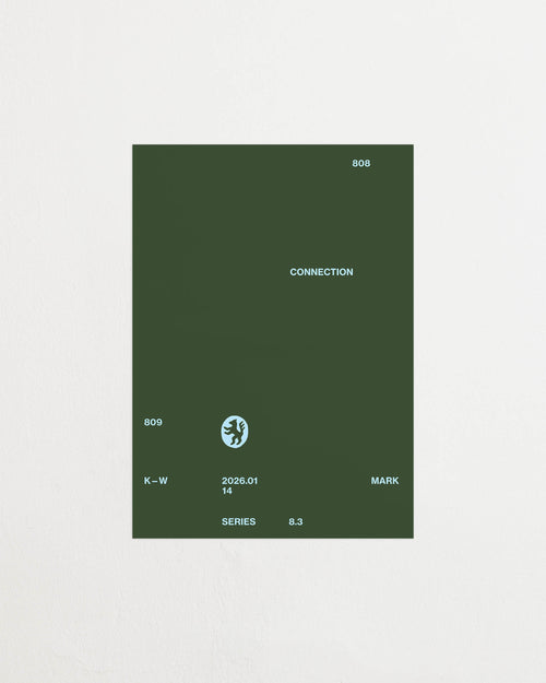 Art print with minimalist, small graphic text elements and a symbol motif in light blue against a moss green background. Styled in a minimalist interior.